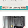 A large four-door mosquito net is draped over a bed, showing its sheer black fabric.