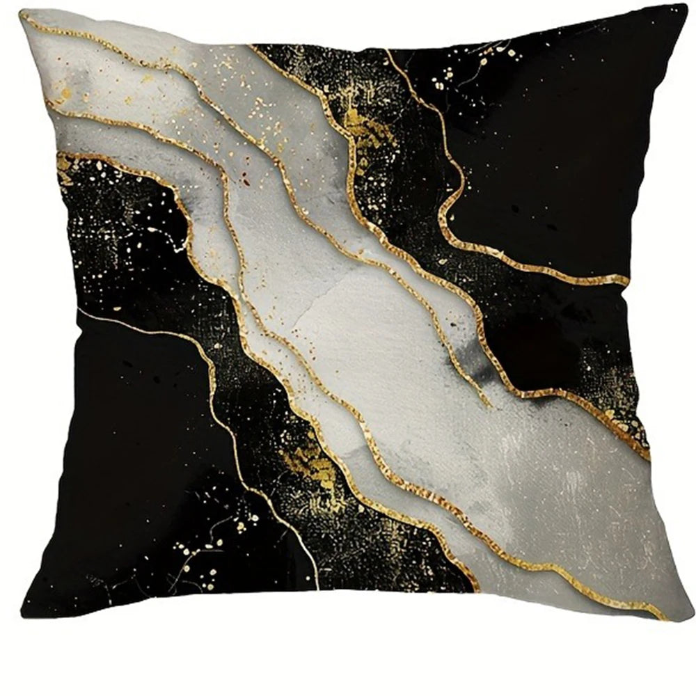 A black and white marble print decorative pillow cover with gold leaf accents.