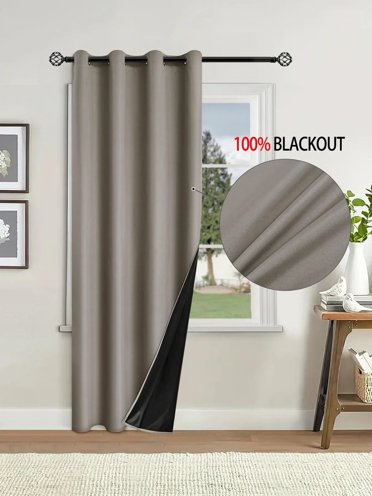 A floor-length gray blackout curtain hanging on a rod next to a window.