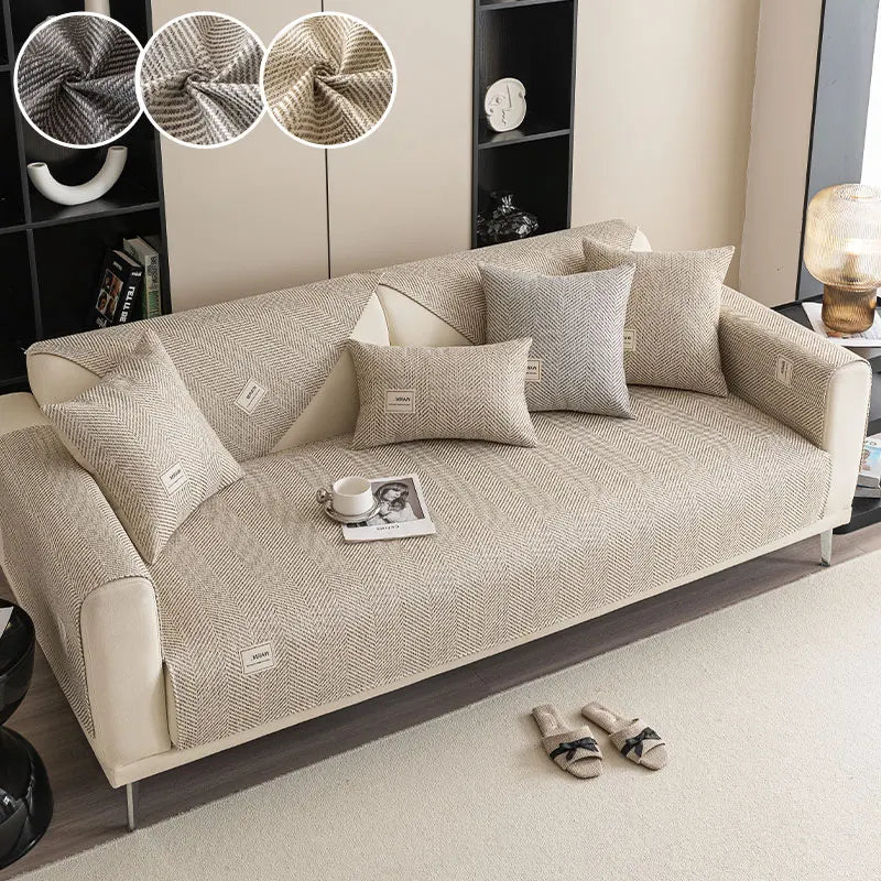 A beige sofa cushion with a textured fabric is displayed on a light-colored floor.