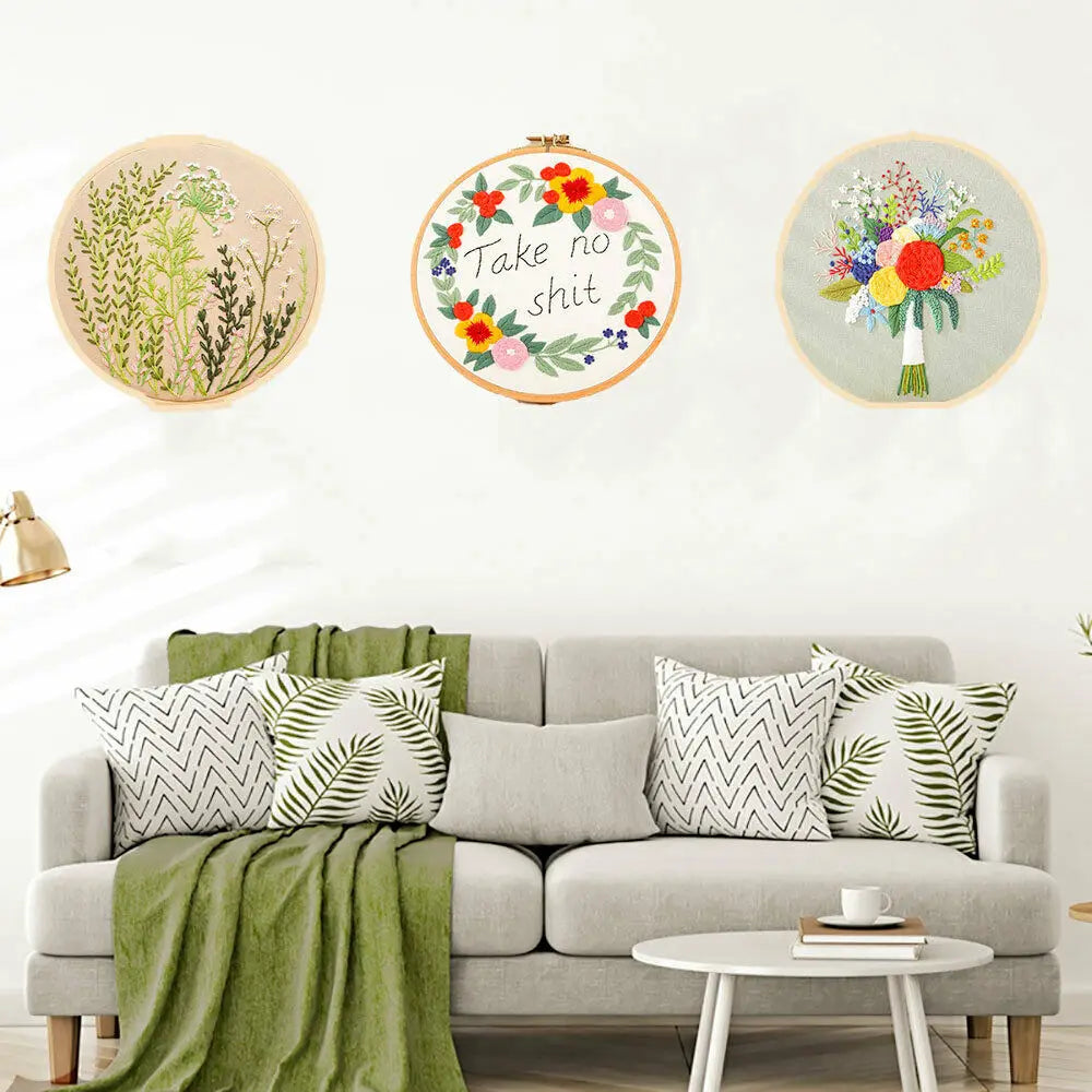A set of three circular floral cross stitch embroidery kits featuring various botanical designs on a white background.