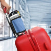 A hand is placing a cup holder device onto a red suitcase for hands-free travel.