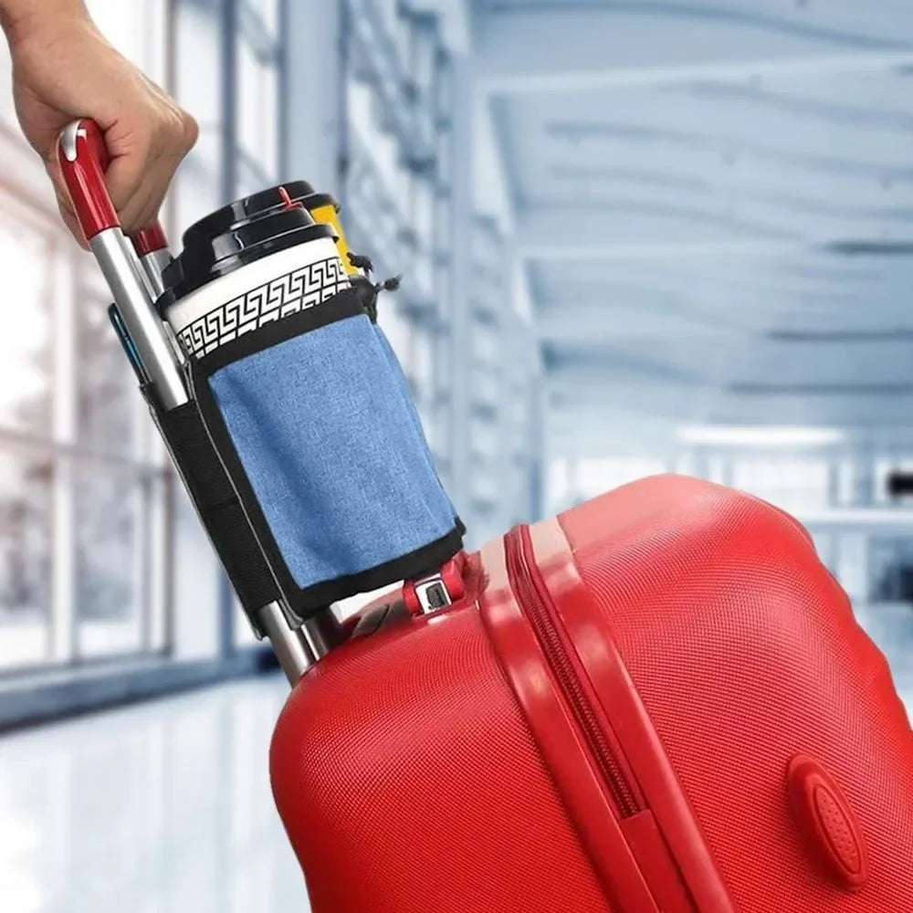 A hand is placing a cup holder device onto a red suitcase for hands-free travel.