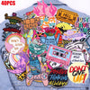 A collection of colorful embroidered letter slogan patches on a denim shirt.