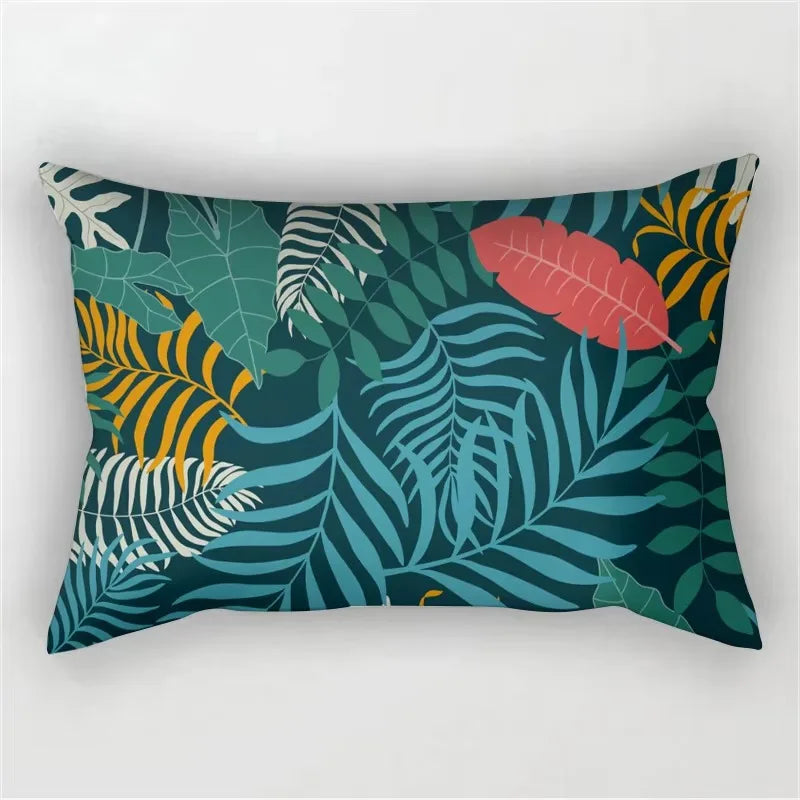 A dark teal and green tropical leaf print pillowcase featuring various shades of green, yellow, and pink leaves.