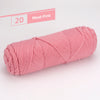 A skein of pink yarn labeled Meet Pink, showing a tightly wound ball of premium worsted cotton yarn.