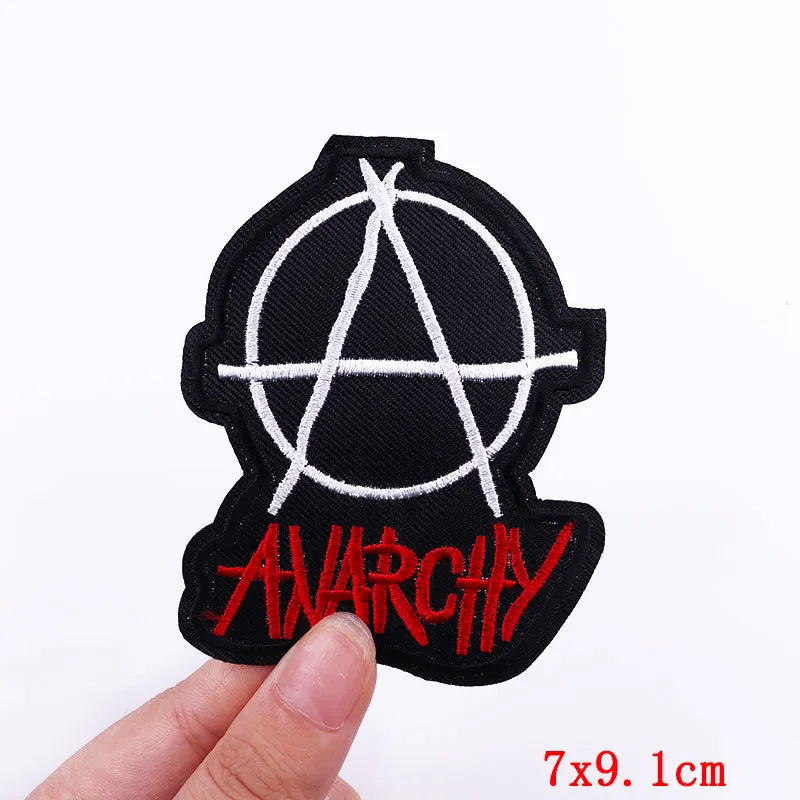 Black embroidered patch featuring a white anarchist symbol and the word ANARCHY in red script