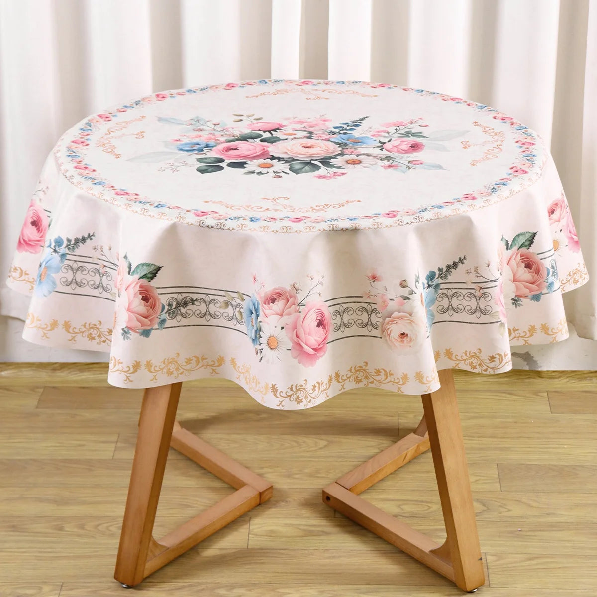 Vintage pink rose sunflower floral tablecloth displayed on a wooden table stand.