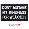 Black iron-on embroidered letter patch with white text that reads Don't mistake my kindness for weakness