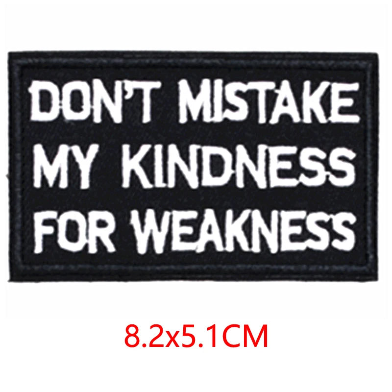 Black iron-on embroidered letter patch with white text that reads Don't mistake my kindness for weakness
