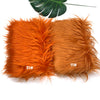 Two bundles of bright orange faux fur plush fabric for sewing and crafting