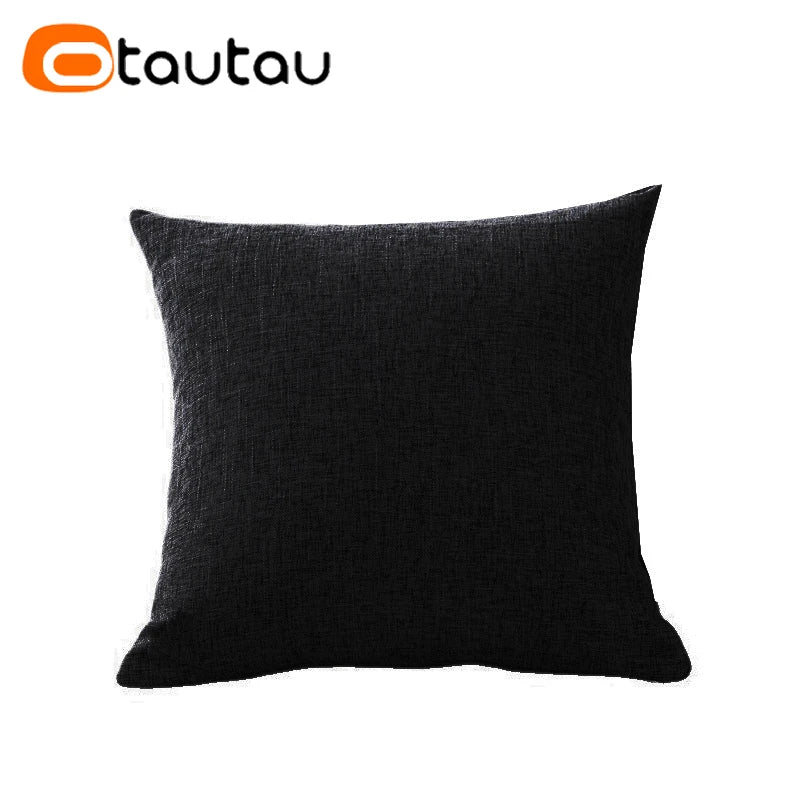 A dark gray or black linen cushion cover with a button closure.