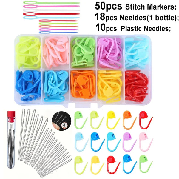 A collection of various plastic and metal sewing needles, stitch markers, and plastic needles in multiple colors.