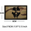 An embroidered patch featuring a blackbeard skull pirate design on a tan fabric with hook and loop backing.