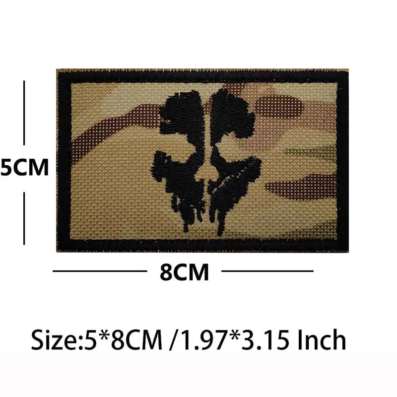 An embroidered patch featuring a blackbeard skull pirate design on a tan fabric with hook and loop backing.