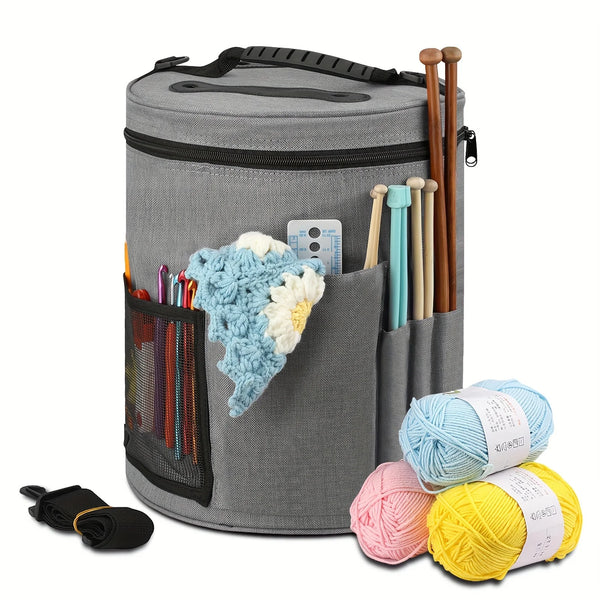 A gray crochet tote bag filled with various yarns and wooden knitting needles.