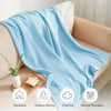 Light blue breathable moisture-wicking extra soft cotton gauze blanket draped over a sofa.