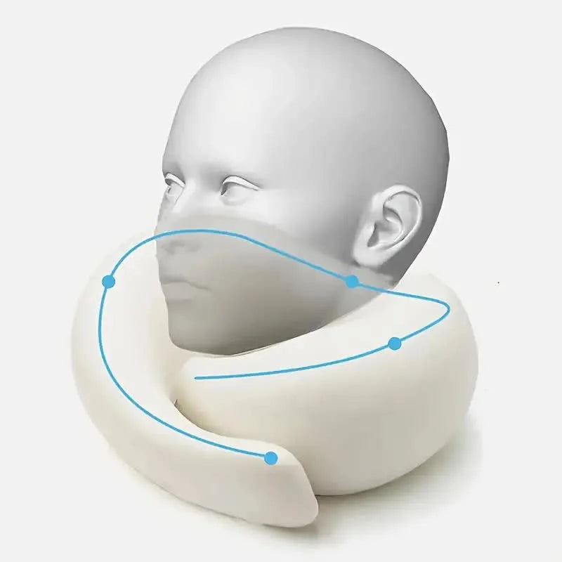 A white memory foam travel neck pillow demonstrating its contoured shape for neck support.