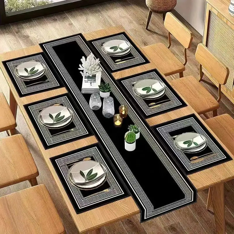 A set of minimalist geometric table runner placemats with gold accents and silver bowls on a wooden table.