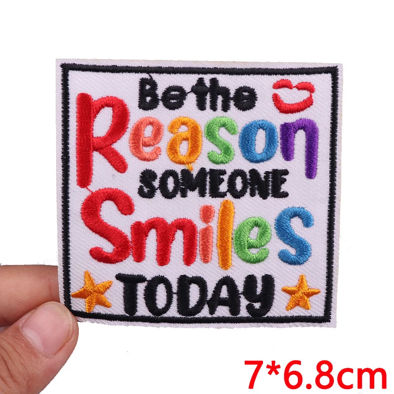 Embroidered patch with the text Be the reason someone smiles today in colorful thread.