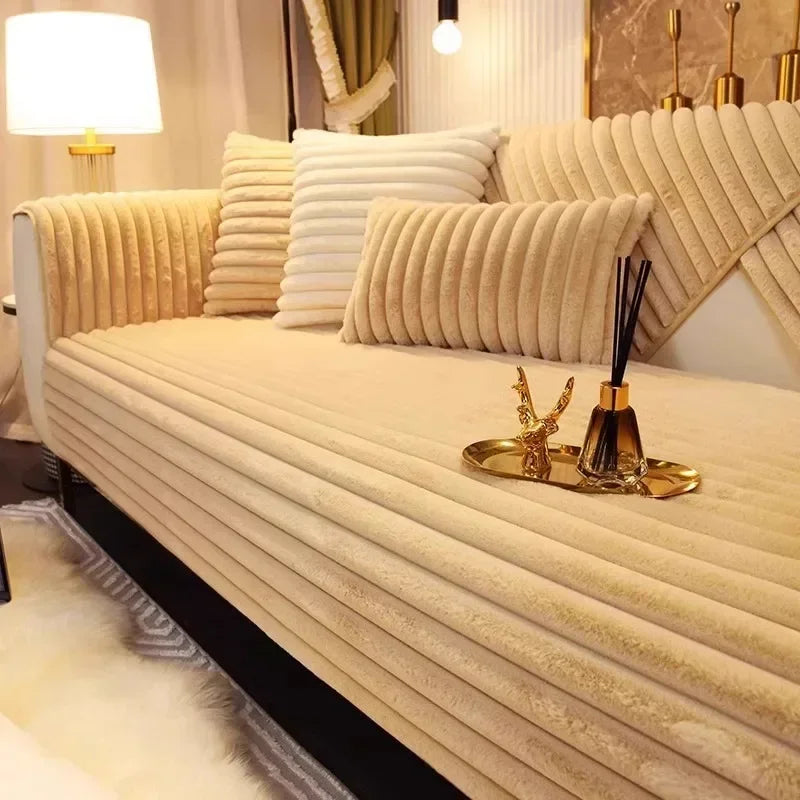 A beige plush sofa seat cushion cover with vertical pleats and gold decorative accents.