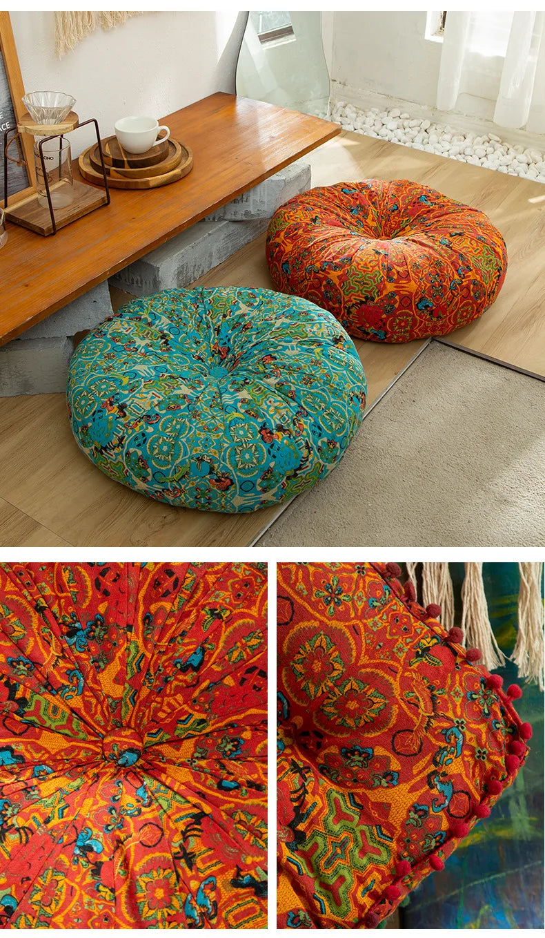 A vibrant orange and teal bohemian cotton linen throw cushion resting on a wooden table.