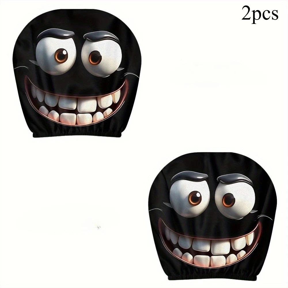 Two black decorative smiley face car pillow covers with wide open mouths and eyes