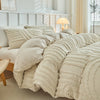 A beige embossed floral duvet cover set with textured fabric and pillows on a bed.