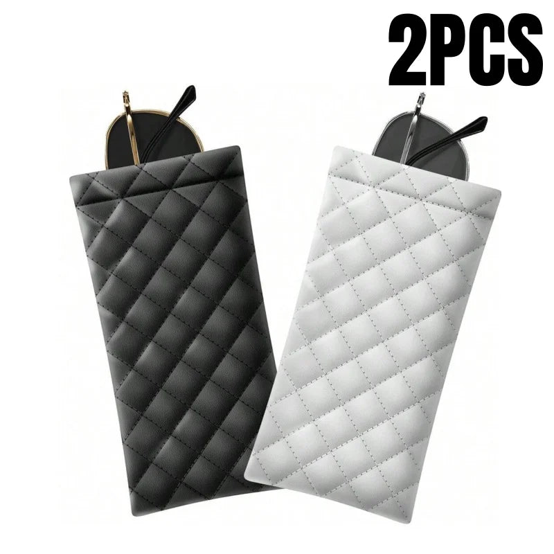 Two quilted PU leather eyeglass cases in black and white with cleaning cloths