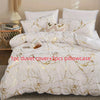 White duvet cover set with gold marble print and two pillowcases displayed on a bed.