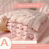 Pink bubble yarn summer cool quilt being held by a hand.
