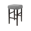 A gray fabric slipcover for a bar stool with dark wooden legs and a padded seat.