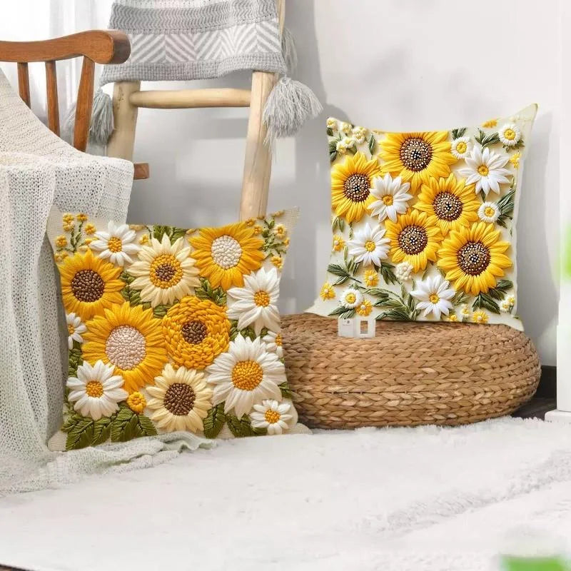 A decorative cushion featuring a floral pattern of yellow and white sunflowers on a light background.