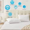 A set of white sleeping pillows displayed on a bed with various eco-friendly certifications and labels.