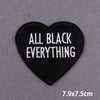 Black heart-shaped embroidered patch with the text All Black Everything
