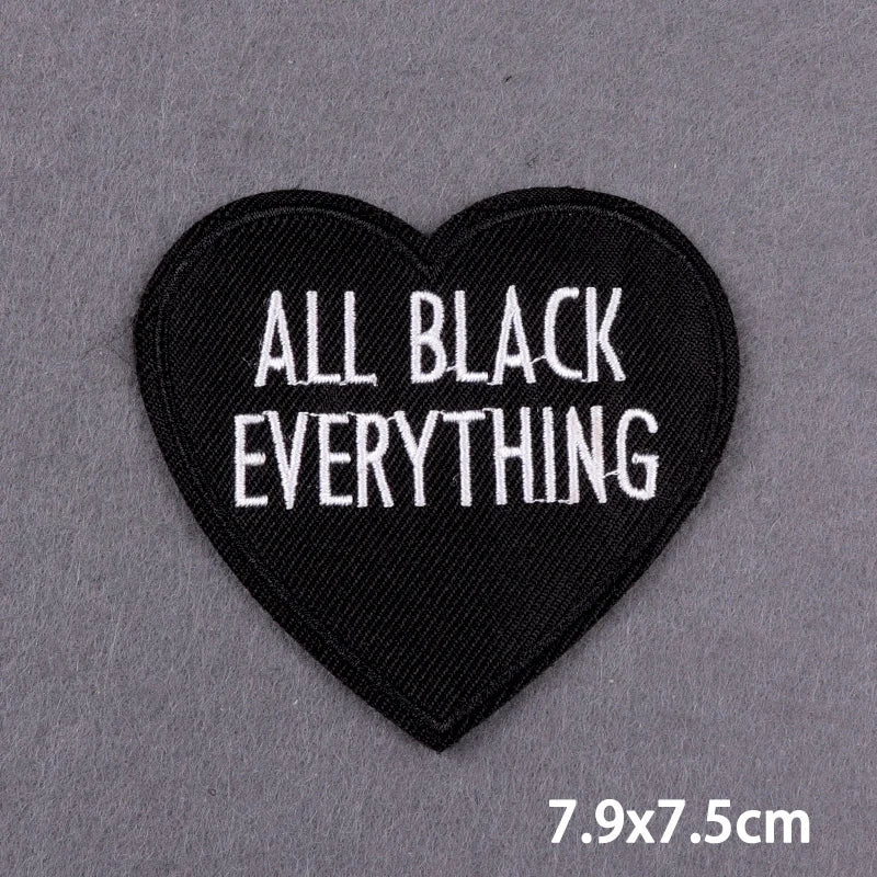 Black heart-shaped embroidered patch with the text All Black Everything