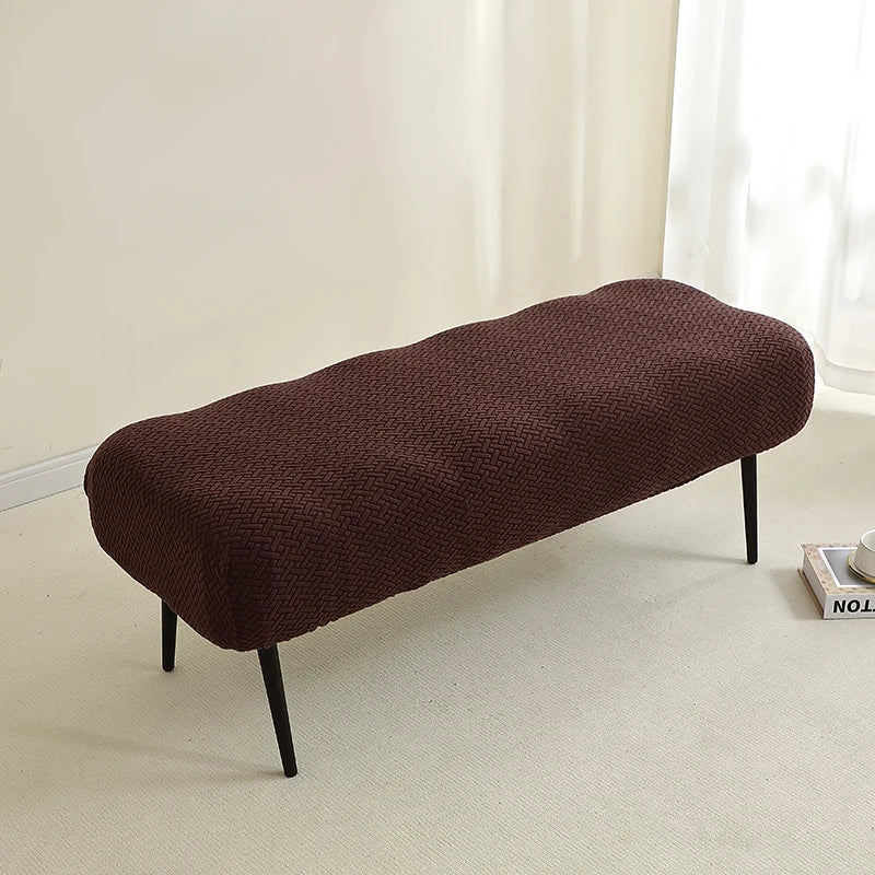 A dark brown elastic jacquard bench cover used as protection for seating.