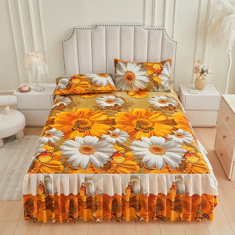 A floral ruffle bed skirt set featuring orange and white sunflowers and bees on a yellow background.