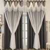 Pair of gray blackout curtains with white wave pattern trim and sheer fabric hanging in a doorway.