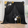 Elegant black curtain panel backdrop decorated with gold and white floral accents for events