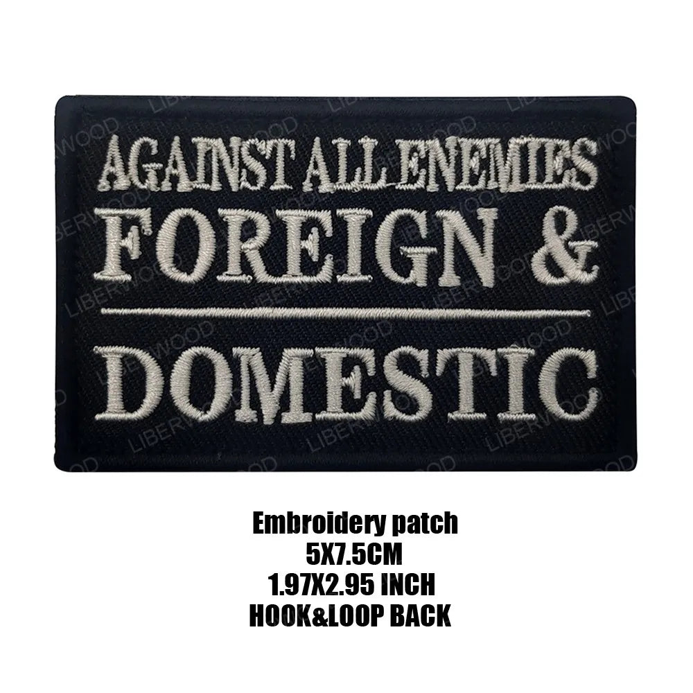 Black embroidered patch with white text reading AGAINST ALL ENEMIES FOREIGN & DOMESTIC