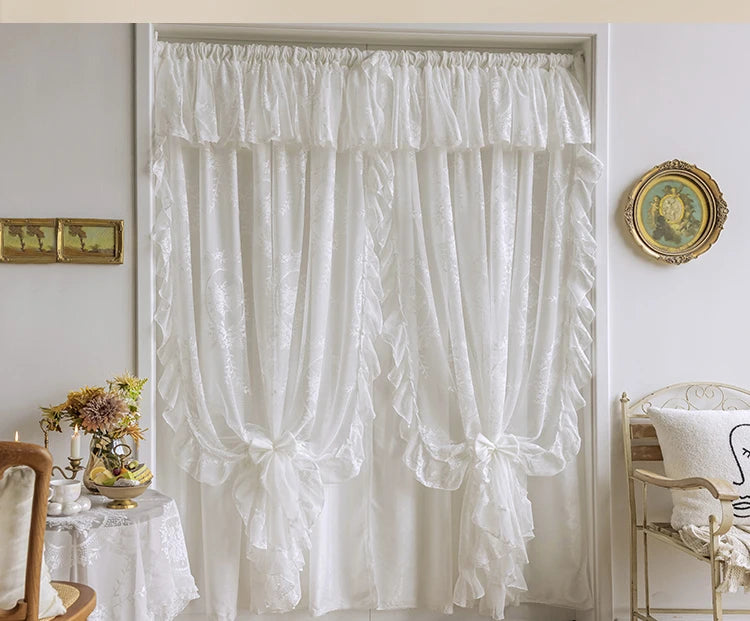 White French Rococo vintage lace curtains hanging in a light-colored window frame.