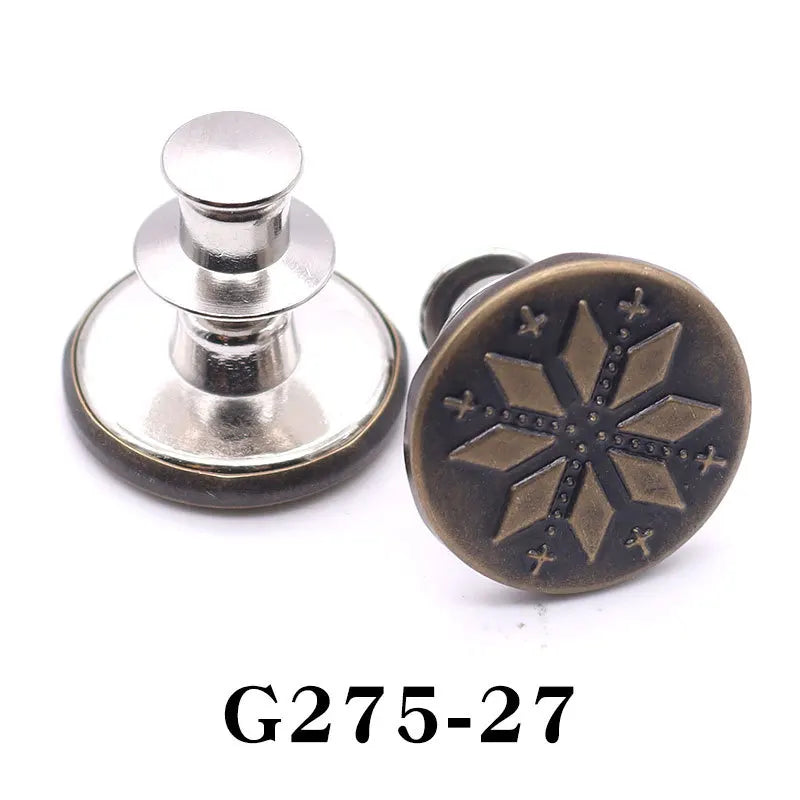 A round, antique bronze button pin with a star design and a silver cap.