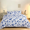 White duvet cover set with blue floral print and matching pillowcases displayed on a bed.
