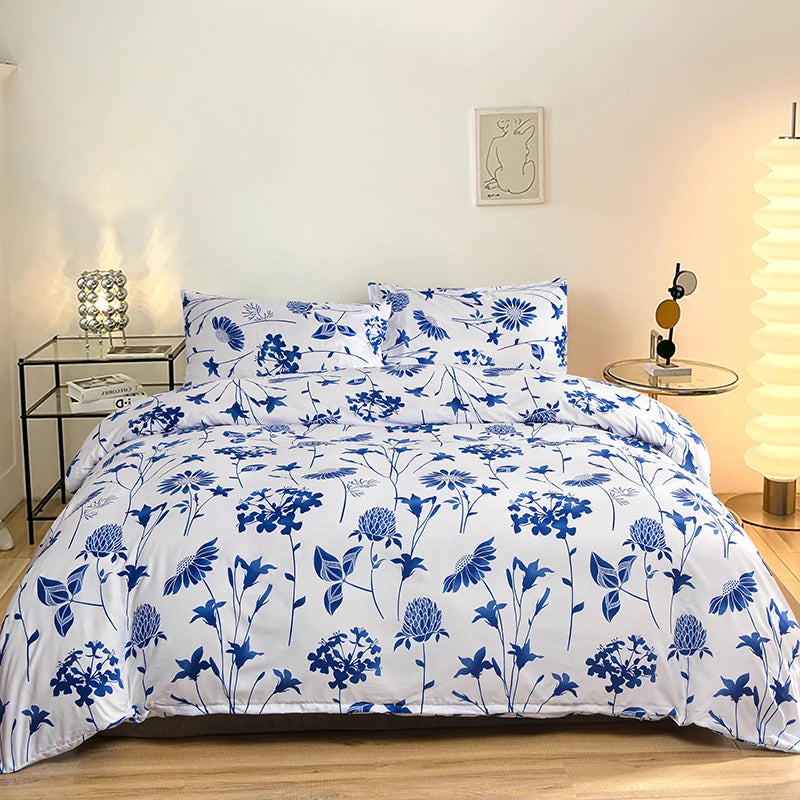 White duvet cover set with blue floral print and matching pillowcases displayed on a bed.