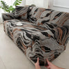 A close-up of a stretchable festive sofa cover featuring a marbled pattern in shades of brown, gray, and black.