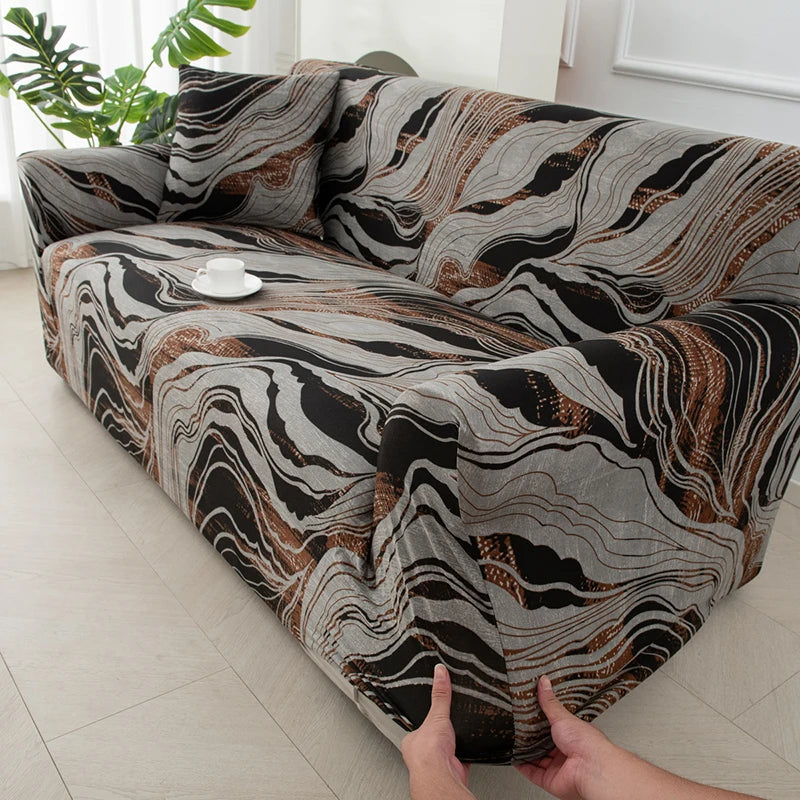 A close-up of a stretchable festive sofa cover featuring a marbled pattern in shades of brown, gray, and black.