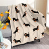 A beige flannel blanket featuring a repeating pattern of black dachshund silhouettes.