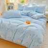 Light blue floral printed bedding set with small white animal patterns on a bed.