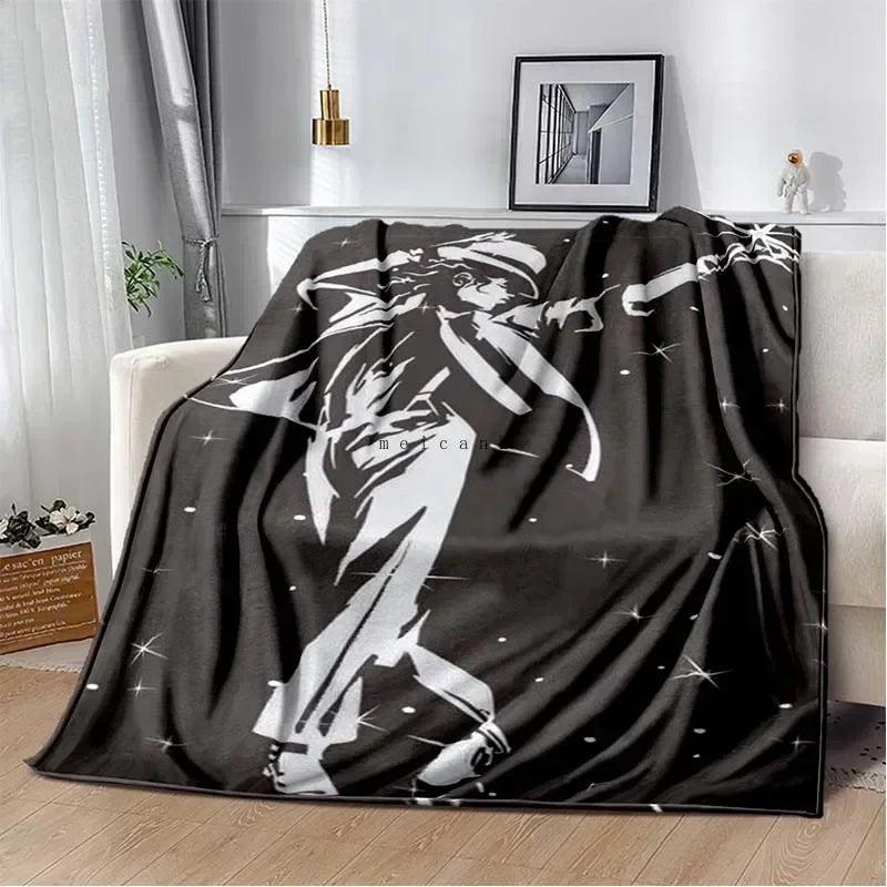 A black and white graphic print of a musician playing a guitar on a flannel blanket.